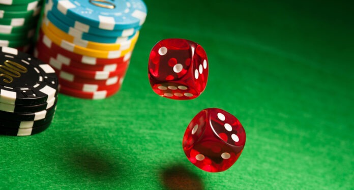 Rolling red dice on a casino table Online Gambling – Make Easy Profits!