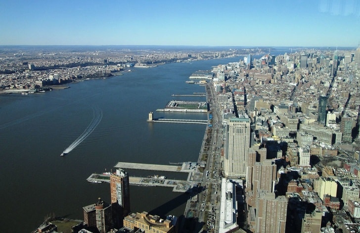 man crosses hudson river in suit