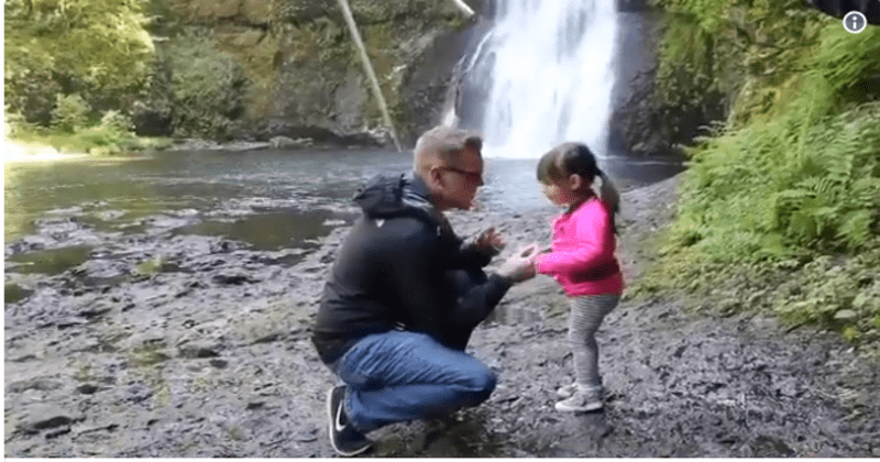 man moved to his knees to impress the little girl
