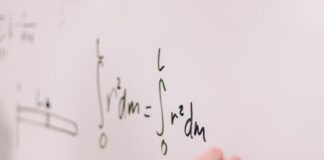 person writing on white paper