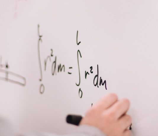 person writing on white paper
