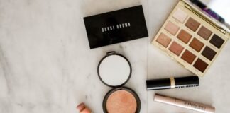 photo of assorted makeup products on gray surface