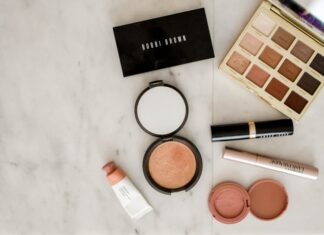 photo of assorted makeup products on gray surface