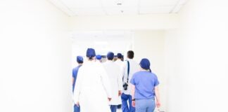 group of doctors walking on hospital hallway