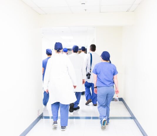 group of doctors walking on hospital hallway
