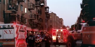 people walking on street near red and white bus during daytime