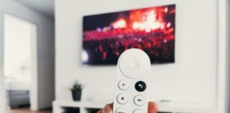 person holding white remote control