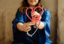 Questions About Job Duties as an LTAC RN in Louisiana girl in blue jacket holding red and silver ring