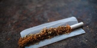 white cigarette stick on brown wooden table