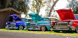 three red, blue, and teal classic cars