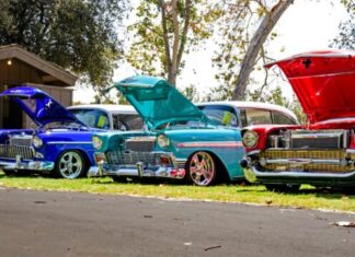 three red, blue, and teal classic cars