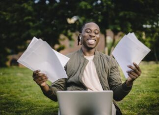 Dilemma: Whom  Can I Pay to Do My Essay for Cheap? Student with documents and laptop happy about getting into university