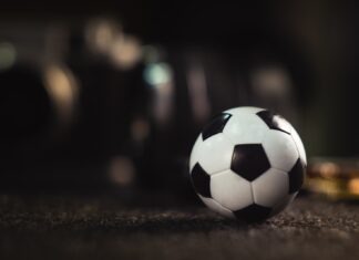 7 Advantages of Online Football Betting That Many People Never Know white and black soccer ball on black sand