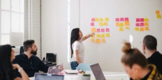 woman placing sticky notes on wall