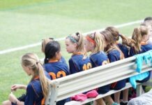The Benefits of Competitive Sports for Children  girls sitting on bench during daytime