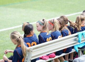 The Benefits of Competitive Sports for Children  girls sitting on bench during daytime