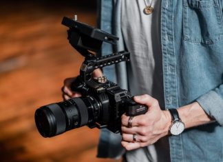 Why Video Content Is Important for Your Business person in blue denim jacket holding black dslr camera