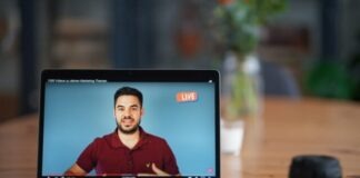 black laptop computer on brown wooden table