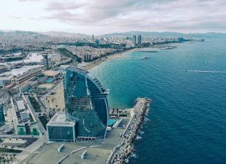 9 Reasons Why Barcelona Is The Perfect Place For Your New Business clear glass building near sea under grey sky