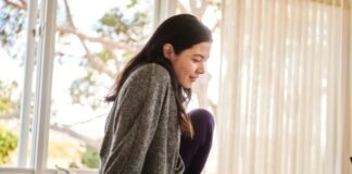 A woman on a bed working on signing a contract with Docusign