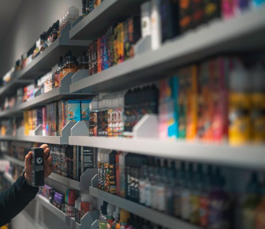 woman in black shirt standing in front of store shelf