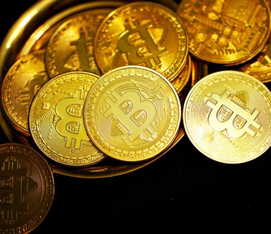 gold round coins on black surface