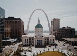 The Current Situation of Bitcoin in Missouri white and green dome cathedral in between high-rise buildings during daytime