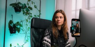 woman in black and white zip up jacket sitting on black office rolling chair