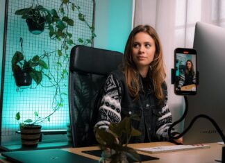 How to Make Money as a Content Creator in 2023 woman in black and white zip up jacket sitting on black office rolling chair