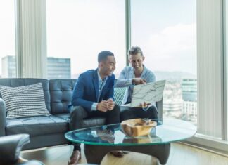 Why Should We Use Bitcoin in Business? two men in suit sitting on sofa