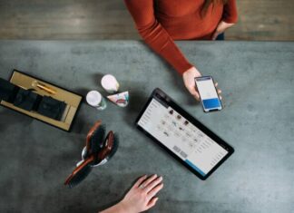 Top-Notch Reasons to Start Bitcoin Payments Today person holding smartphone beside tablet computer
