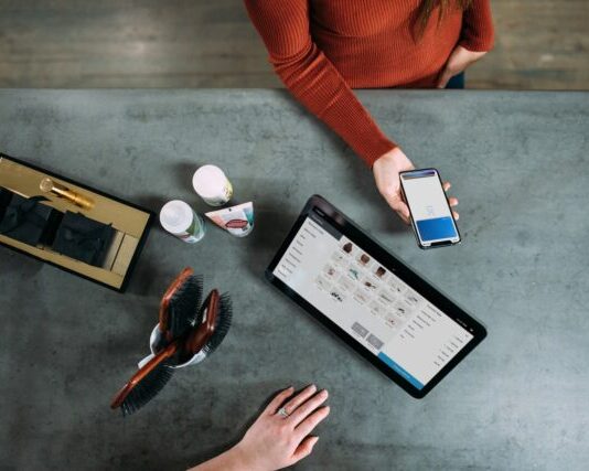 Top-Notch Reasons to Start Bitcoin Payments Today person holding smartphone beside tablet computer