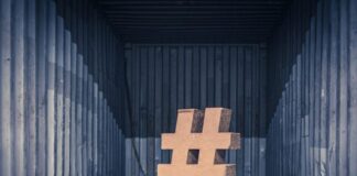 brown ampersand concrete statue inside an intermodal container