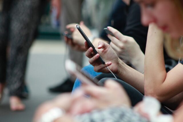 Photo by ROBIN WORRALL person holding black phone