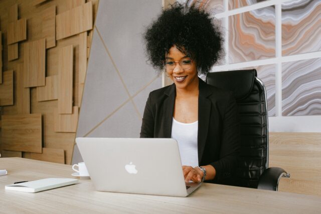 Photo by Anna Shvets Woman in Black Blazer Sitting by the Table While Using Macbook