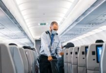 Evaluating Health and Safety in an Airline Facility man in blue dress shirt standing in airplane