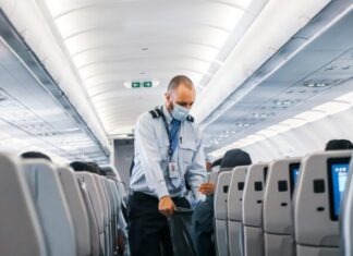Evaluating Health and Safety in an Airline Facility man in blue dress shirt standing in airplane