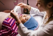 Which Option Is Better: Laser or IPL Treatment An Aesthetician Putting a Sheet Mask on Her Client's Face