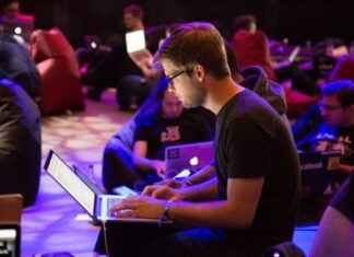 Benefits of Data Annotation man using laptop in front of brown chair