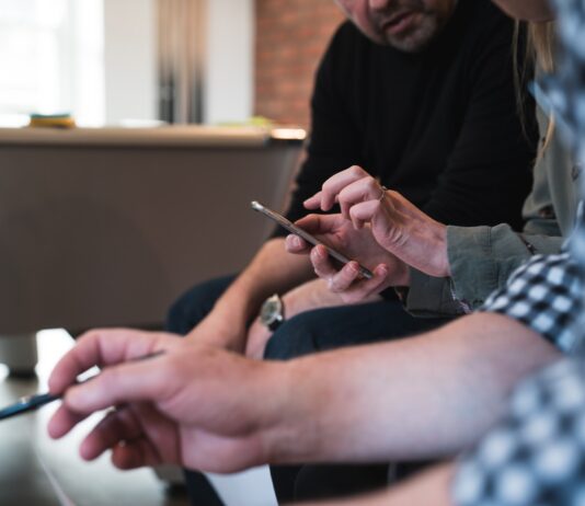 The Importance of In-Home Product Testing for Companies three peson sitting talking to each other