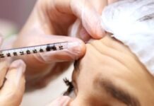 How Can I Prevent Wrinkles a woman getting her eyebrows examined by a doctor