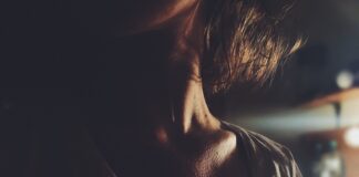 woman standing near brown wooden table