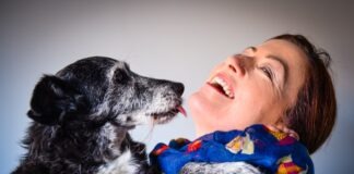 woman in blue and white floral shirt lying on red sofa
