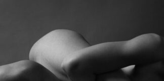 naked woman lying on bed