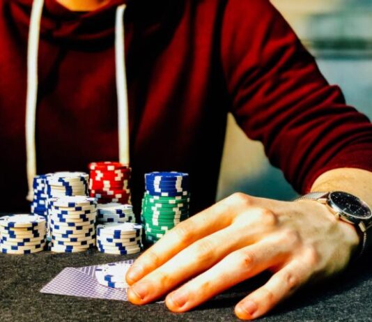Interviews with the Pros: Secrets from Successful Online Gamblers person holding playing cards beside poker chips