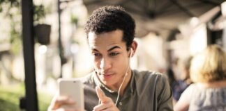 Selective Focus Photo of Man in Brown Button Up Shirt Holding Talking on the Phone