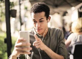Selective Focus Photo of Man in Brown Button Up Shirt Holding Talking on the Phone