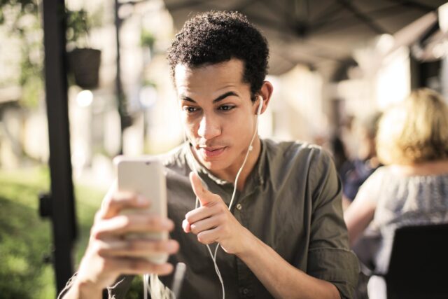 Photo by Andrea Piacquadio Selective Focus Photo of Man in Brown Button Up Shirt Holding Talking on the Phone