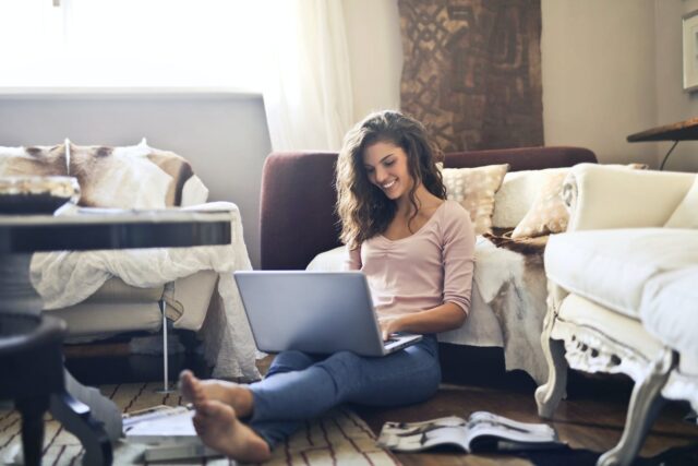 Photo by Andrea Piacquadio Woman Smiling While Using Laptop