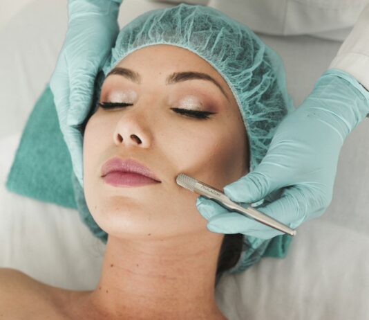 woman doing liposuction on her face